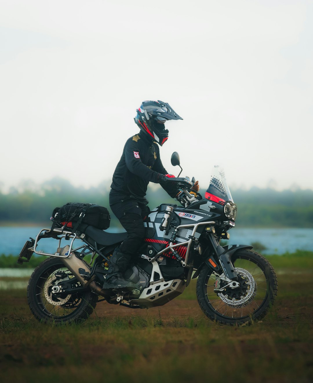 Rider on a motorcycle by a body of water
