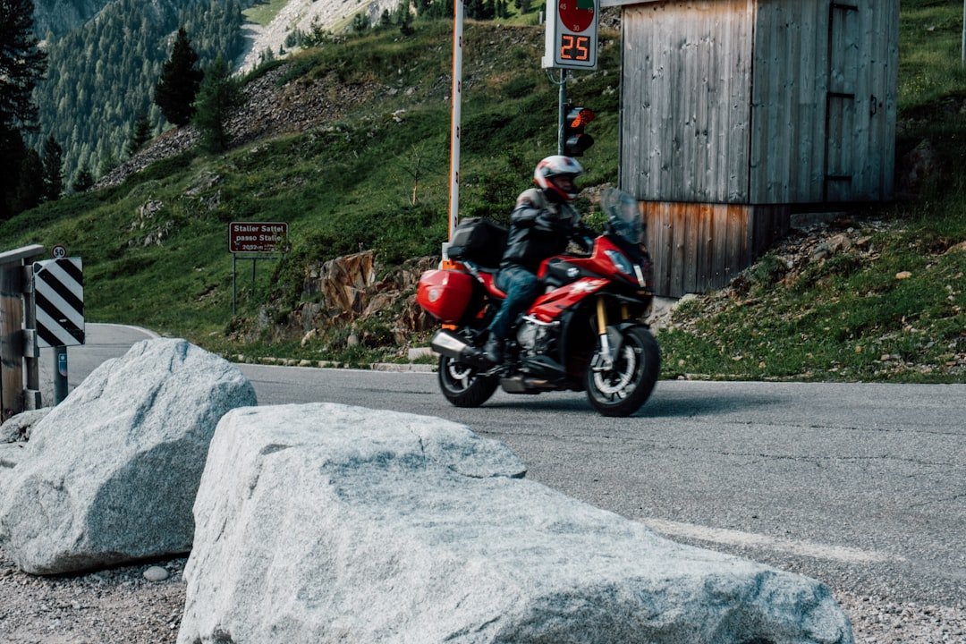 Motorcyclist riding on a scenic mountain road.