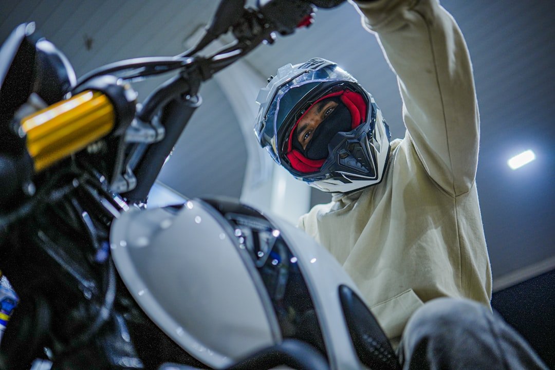 Person in helmet sitting on motorcycle