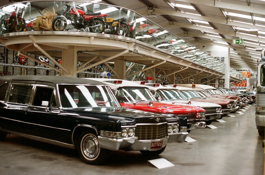 Vintage cars lined up in a museum display hall.