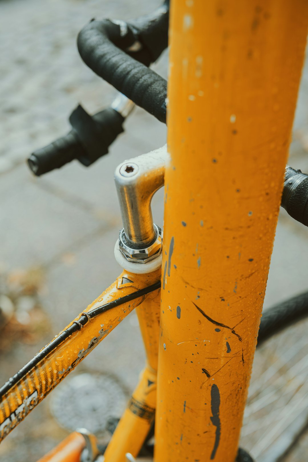 A close up of a yellow bicycle on a city street