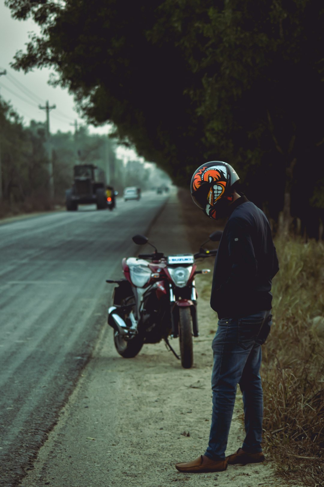man in black jacket riding motorcycle on road during daytime