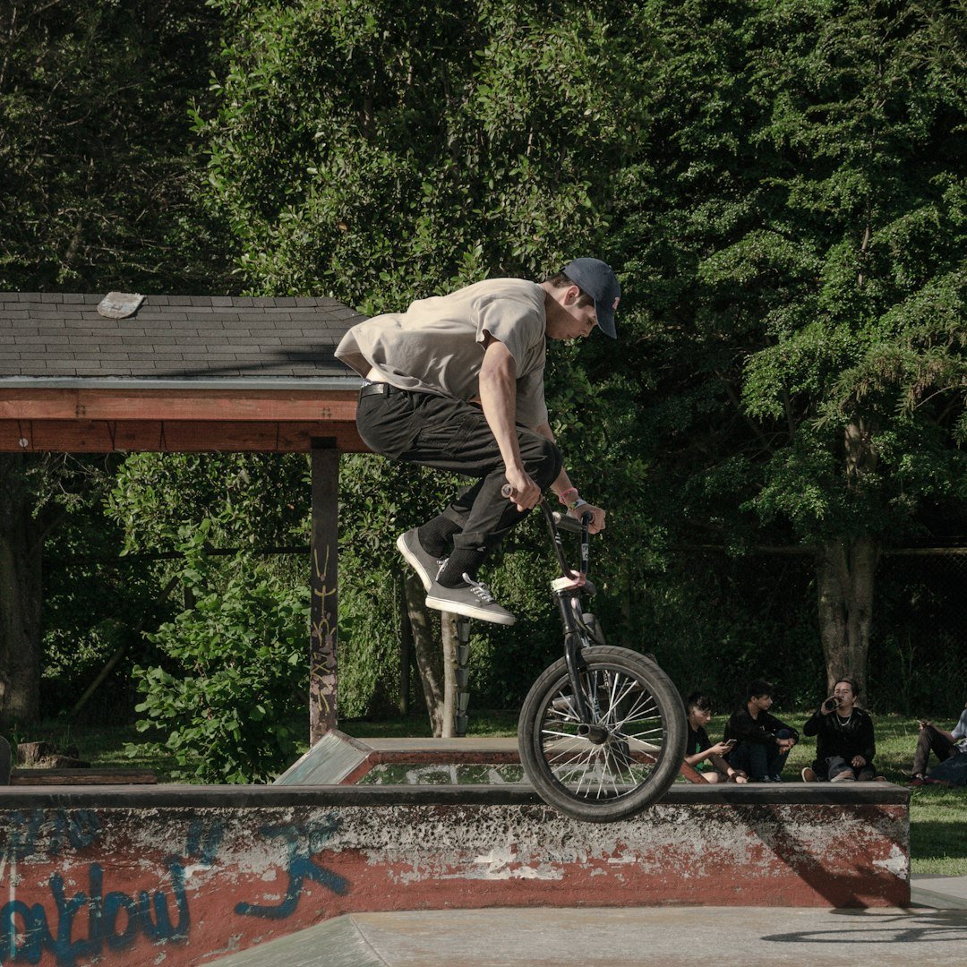 a man doing a trick on a bicycle