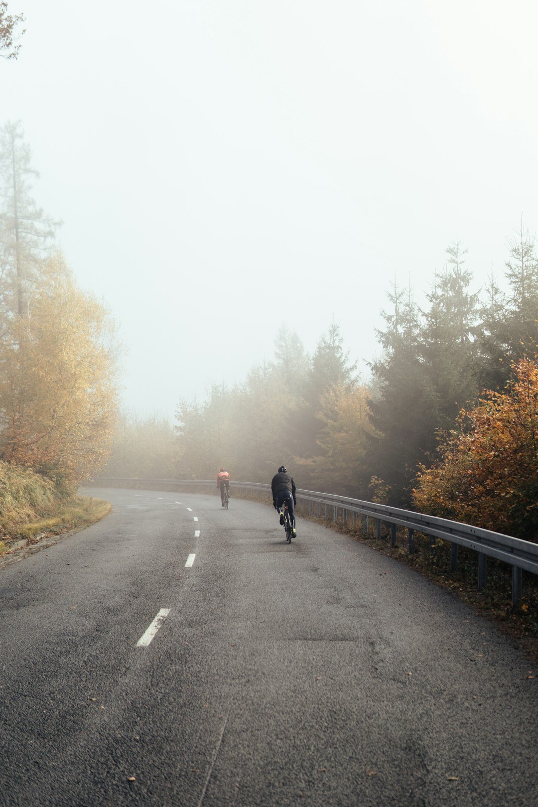 man in black jacket walking on gray concrete road during daytime