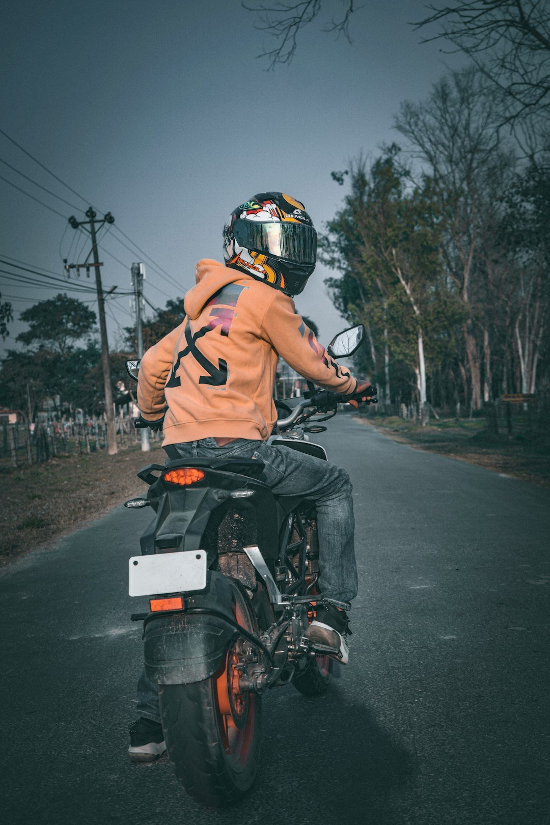 a man riding a motorcycle down a street