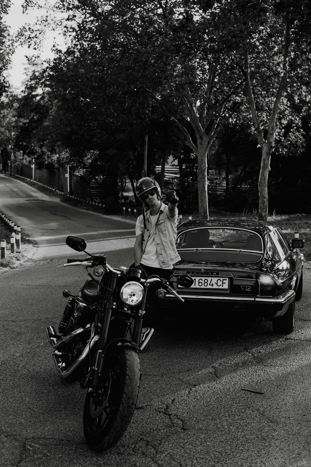a man standing next to a parked motorcycle