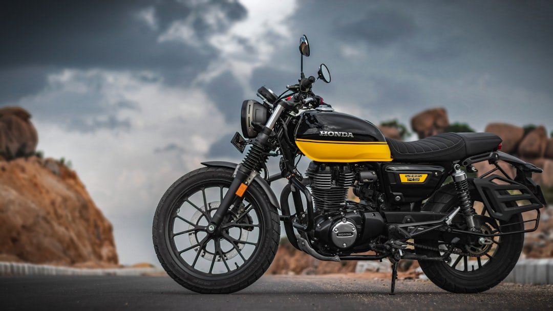 A yellow and black motorcycle parked on the side of a road
