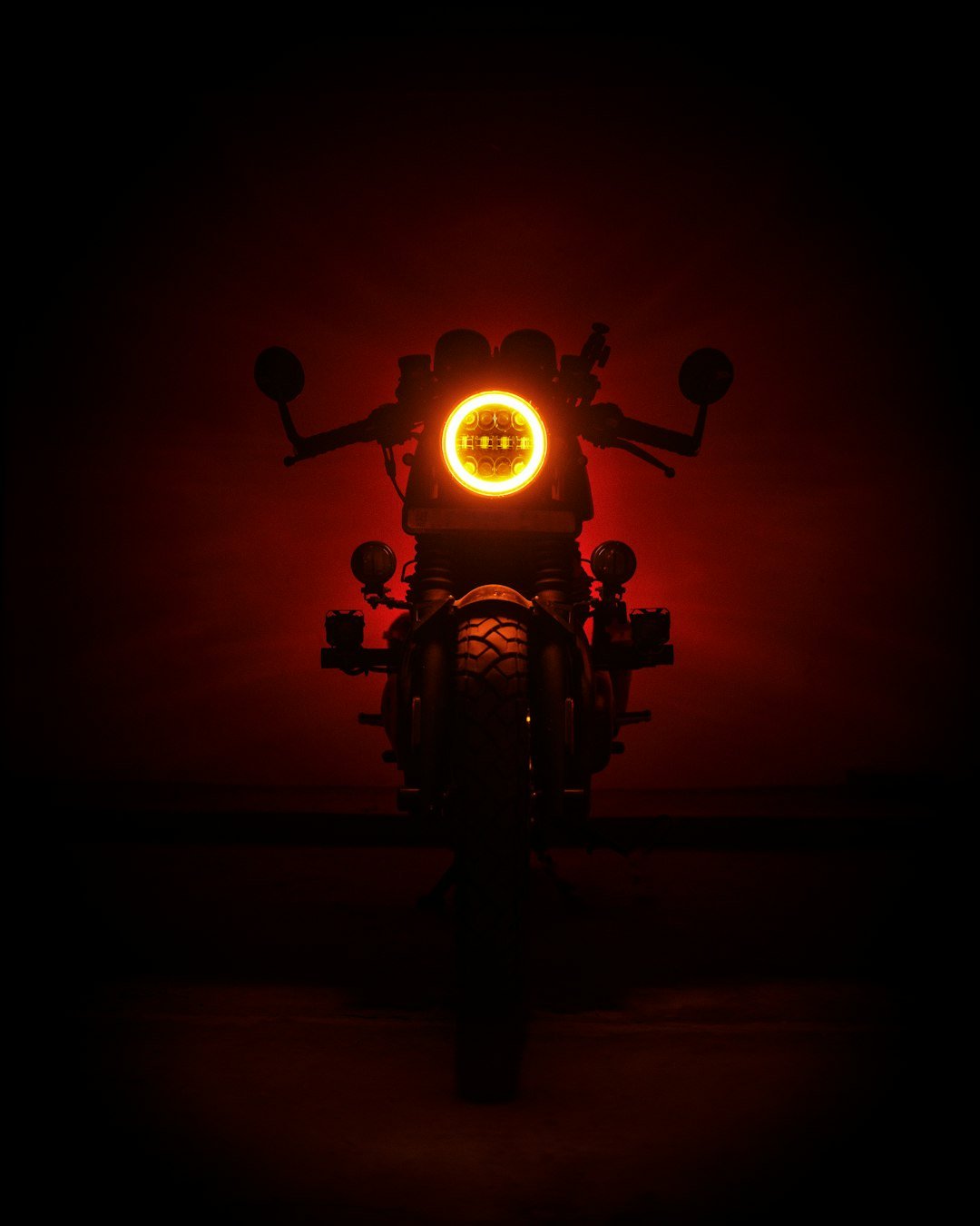 a motorcycle with a red light on it's headlight