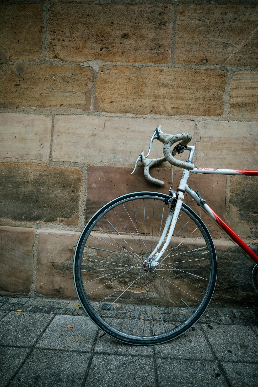 a close up of a bike parked against a brick wall