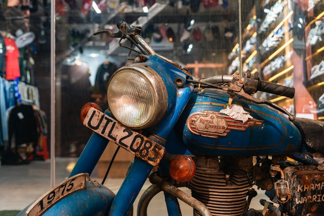 A vintage blue motorcycle with a license plate.