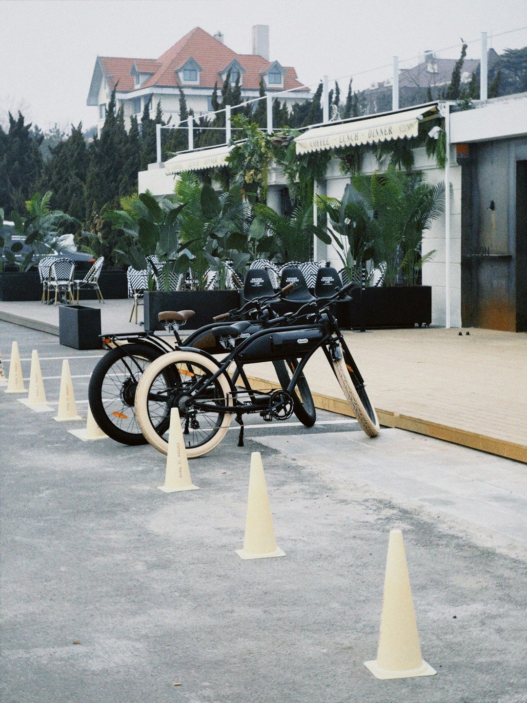 a row of motorcycles parked next to white cones