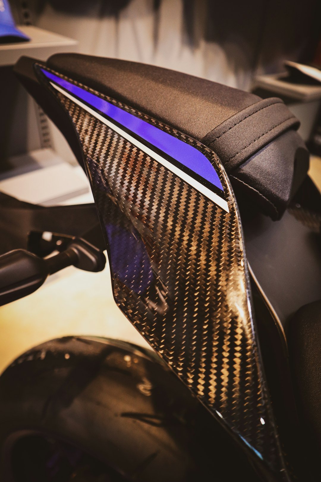 Close-up of a motorcycle's carbon fiber tail section.
