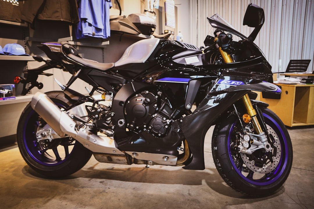 A black and blue sport motorcycle parked indoors.