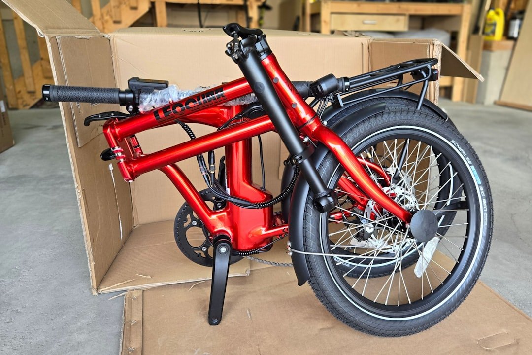 A red bicycle sitting in a cardboard box