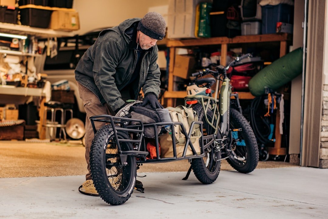 a man working on a bicycle in a garage