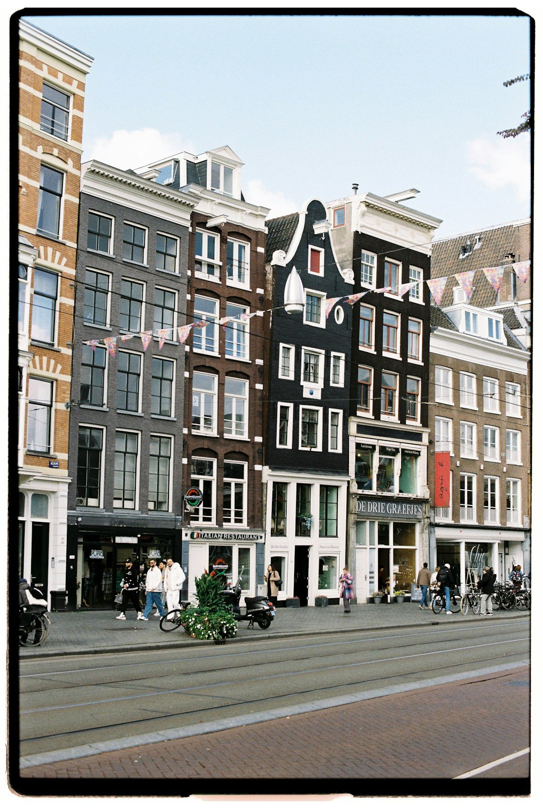 Row of historic buildings along a canal in amsterdam.