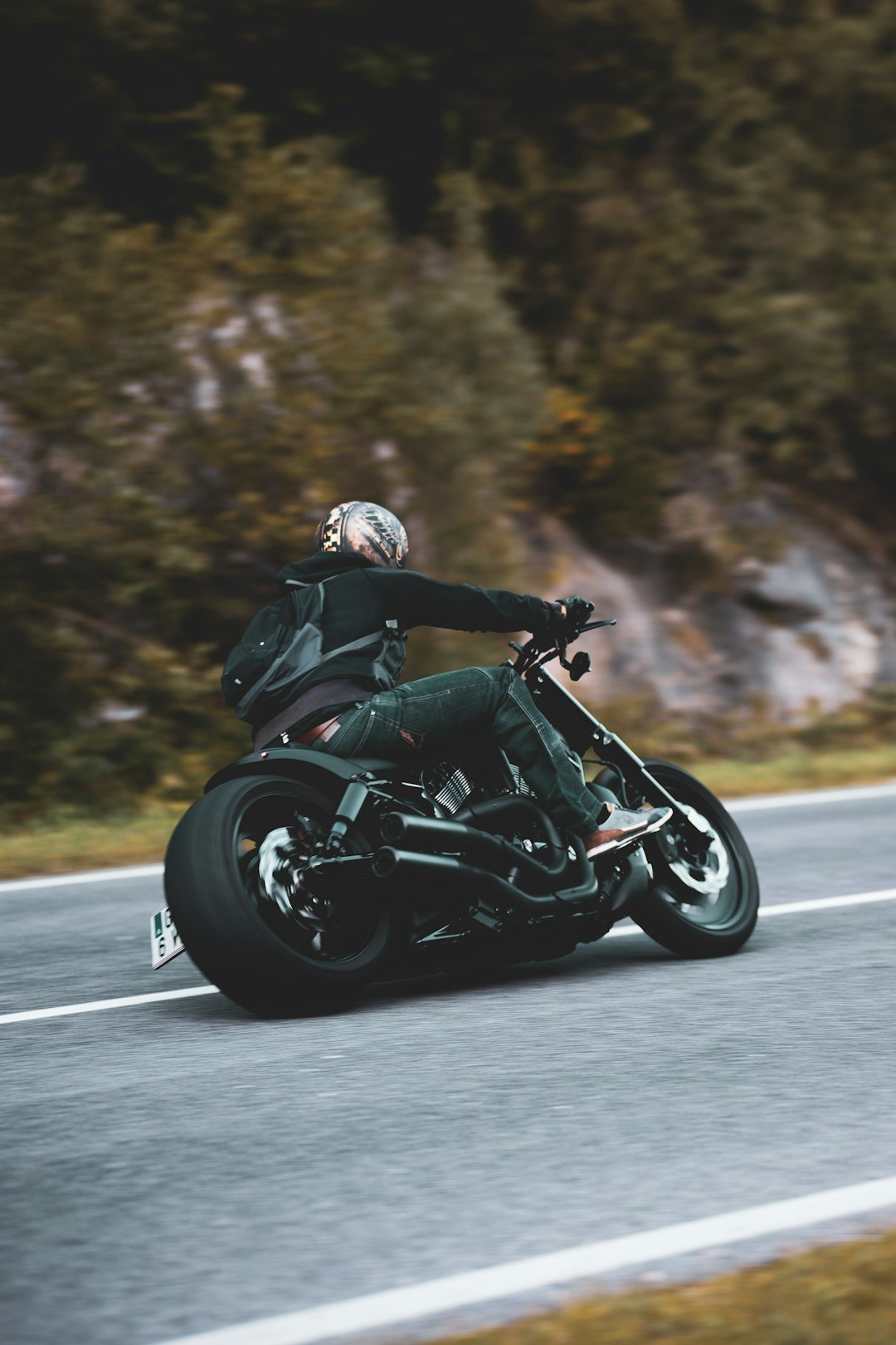 A man riding a motorcycle down a curvy road