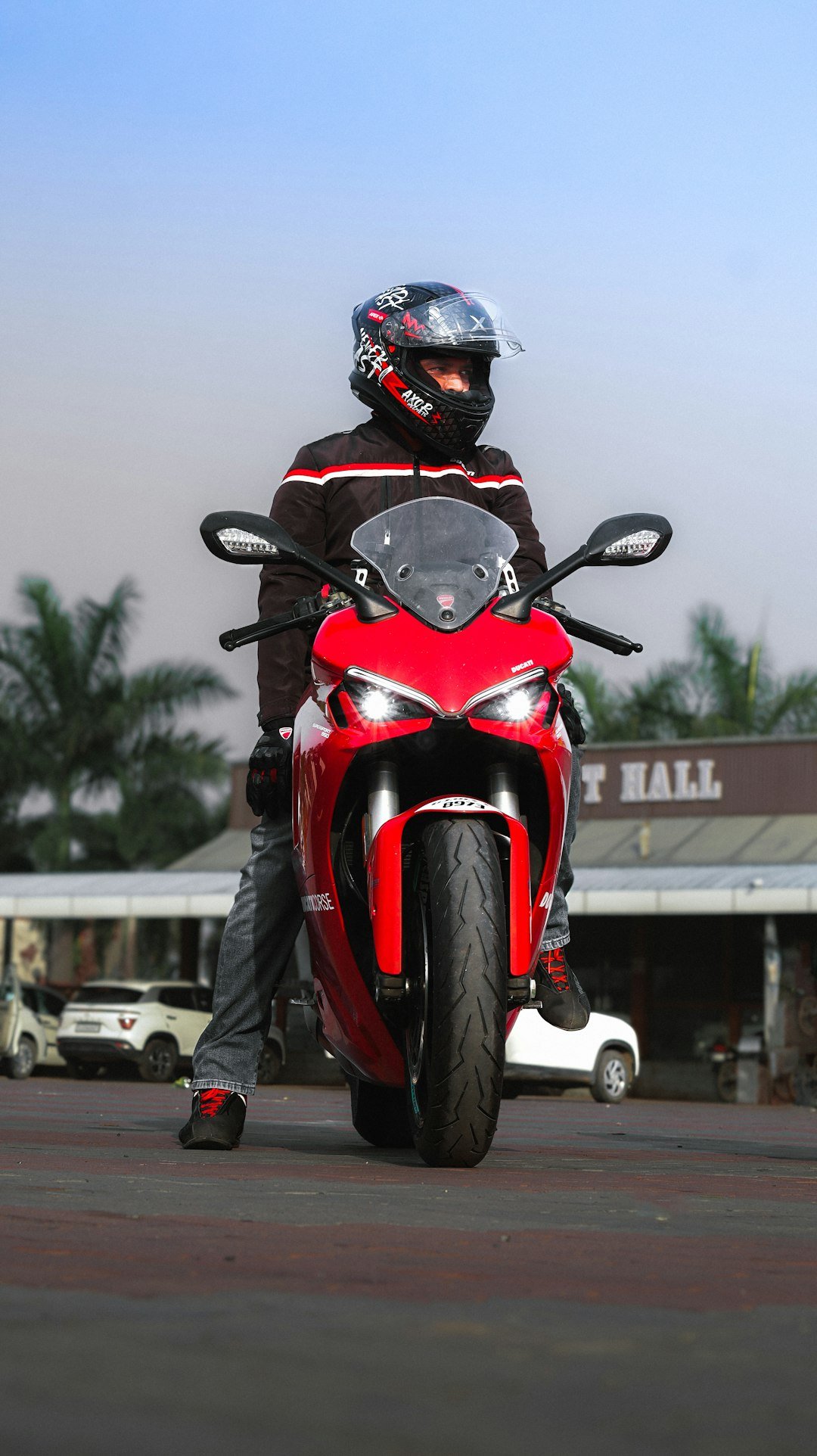 A person on a red sport motorcycle wearing a helmet.