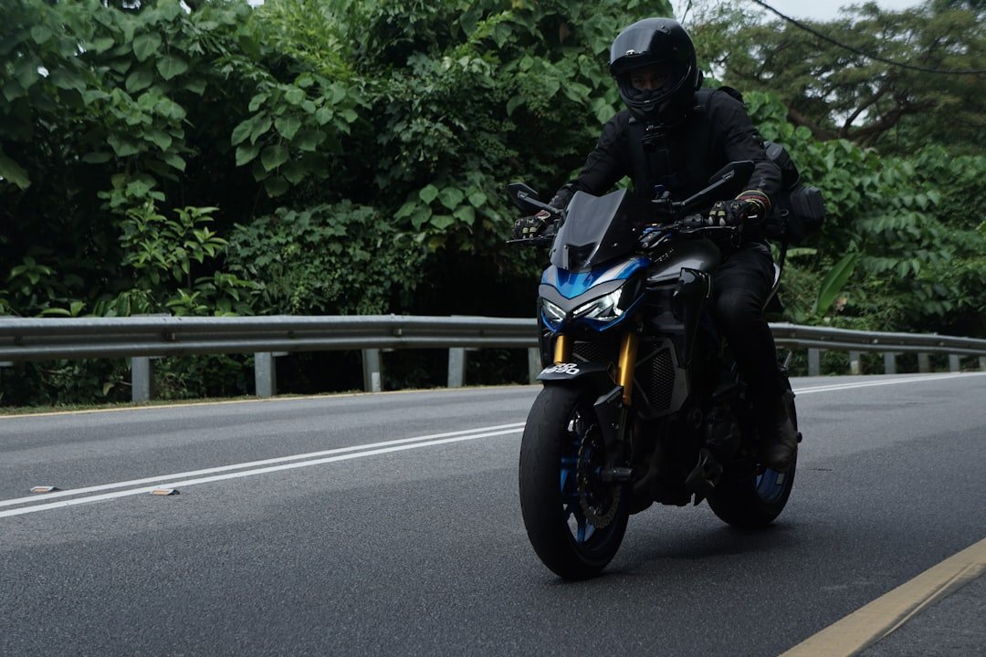 A person rides a motorcycle on a road.