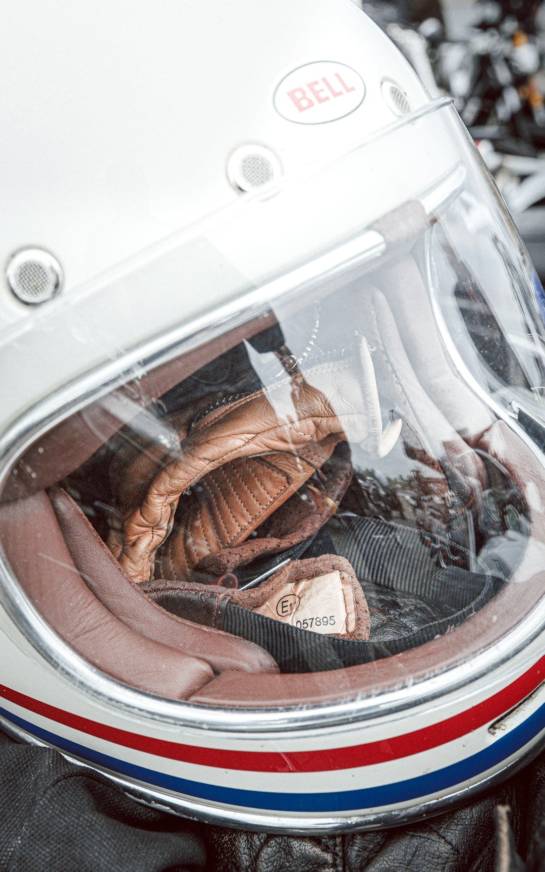 White helmet with clear visor and brown leather interior