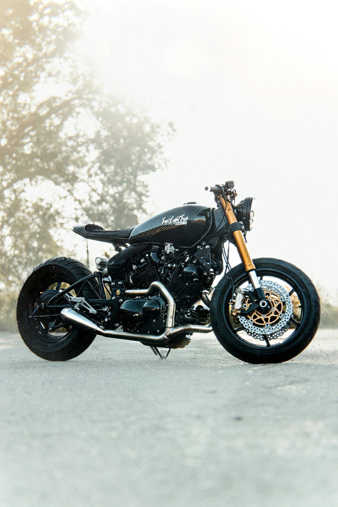 A black custom motorcycle parked on a road.