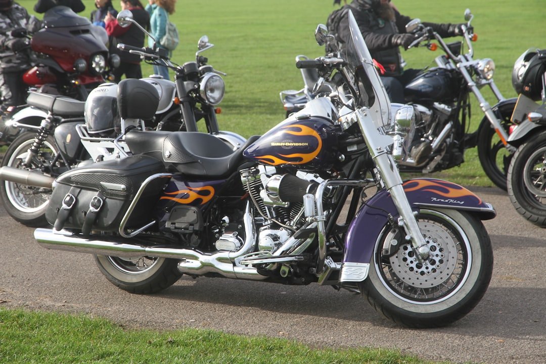 Purple motorcycle with orange flames parked outside