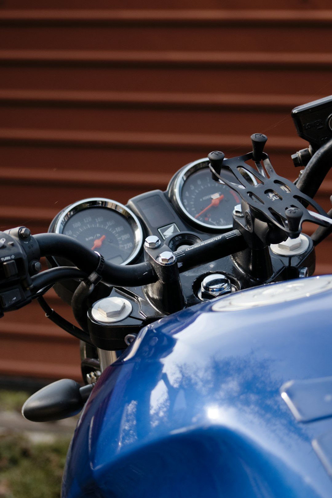a blue motorcycle with a black handlebar