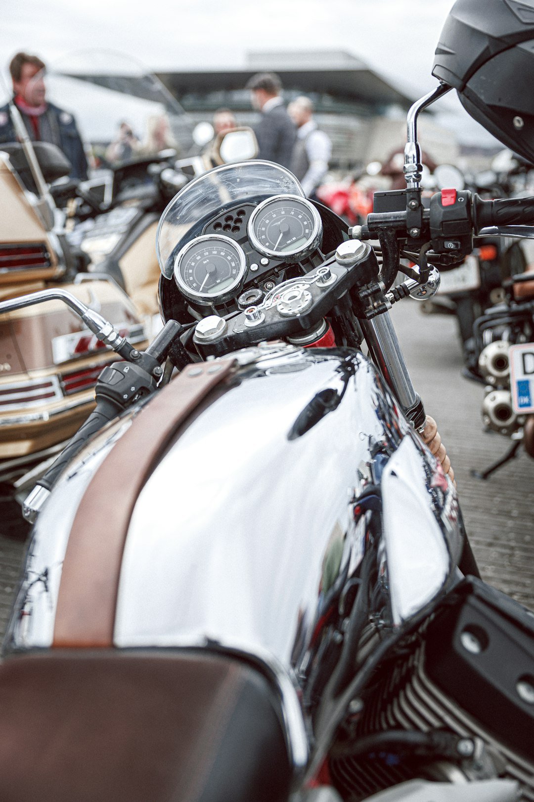 Close-up of a shiny chrome motorcycle with brown accents.