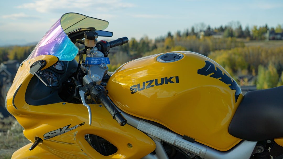 Yellow suzuki motorcycle with a scenic background