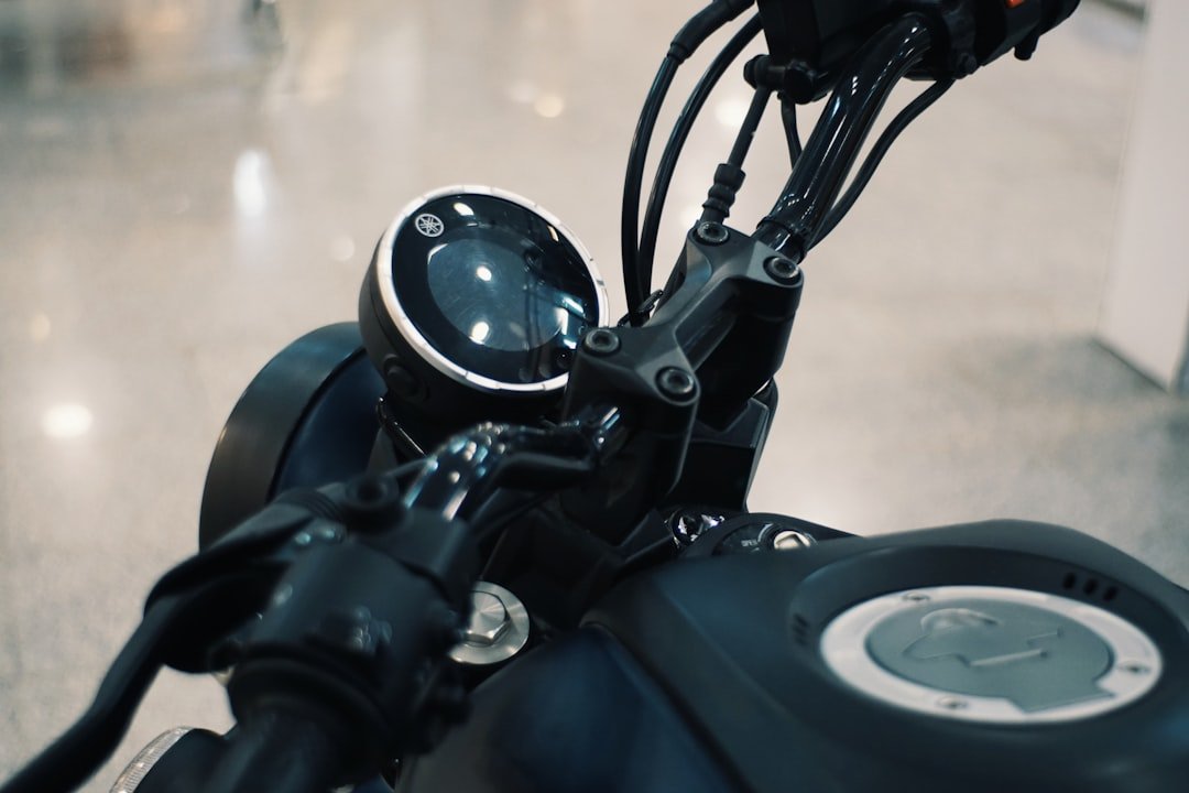 Close-up of a motorcycle's handlebars and dashboard.