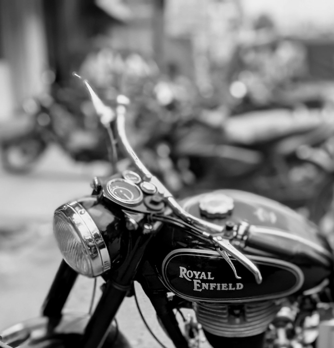 Black and white close-up of a vintage royal enfield motorcycle.