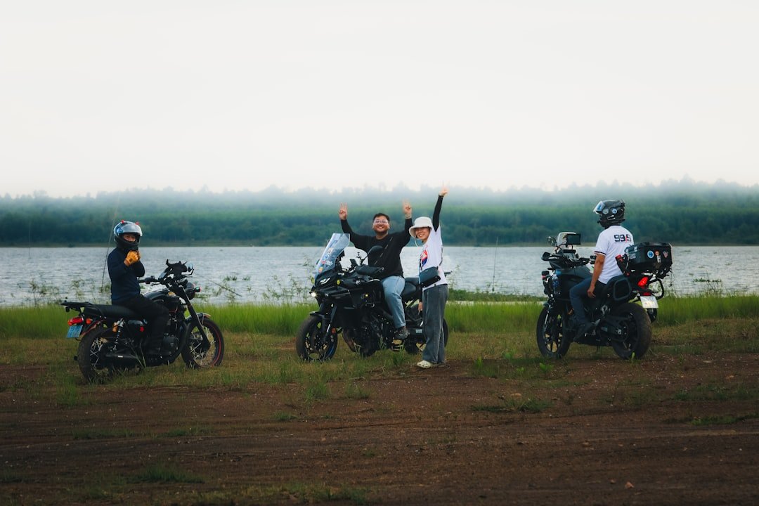Group of friends with motorcycles by a lake