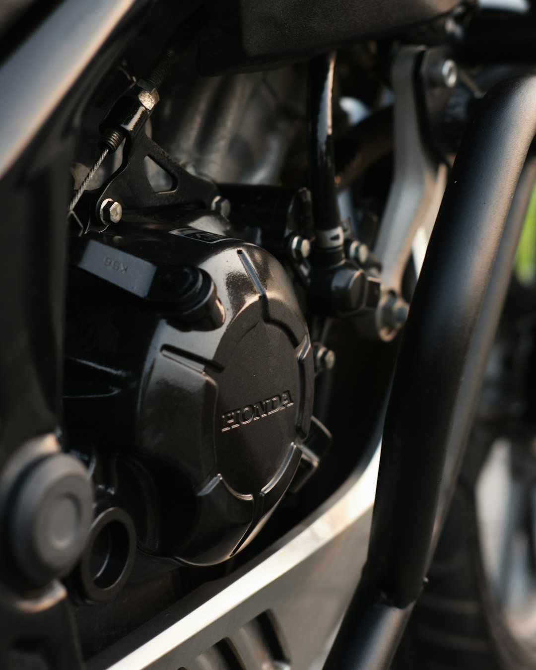 Close-up of a black motorcycle engine with honda logo.