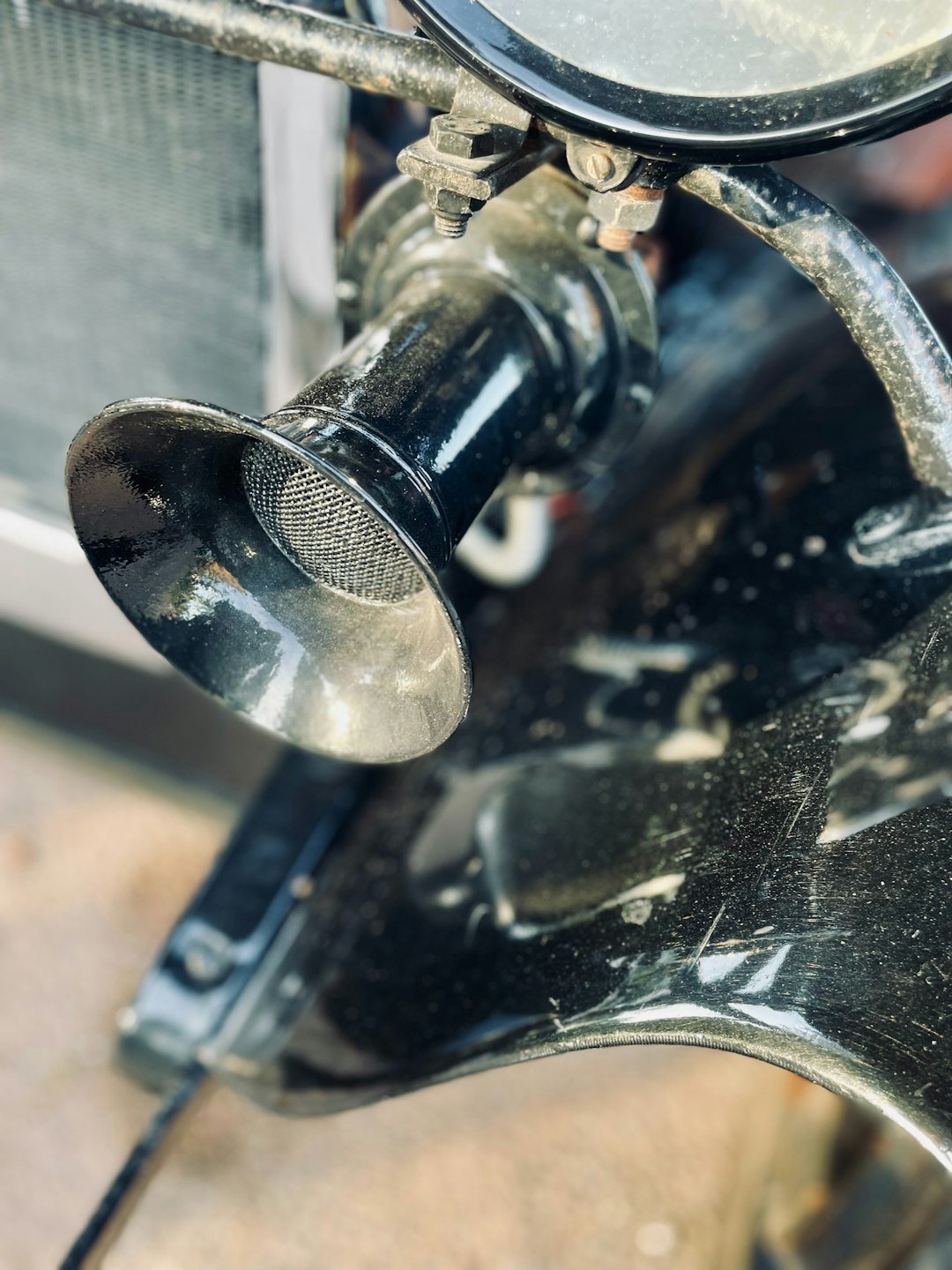 Close-up of a vintage motorcycle air intake horn.