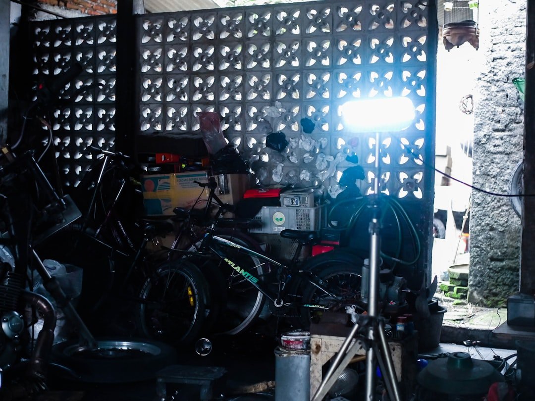 Bicycles and equipment in a cluttered workshop.