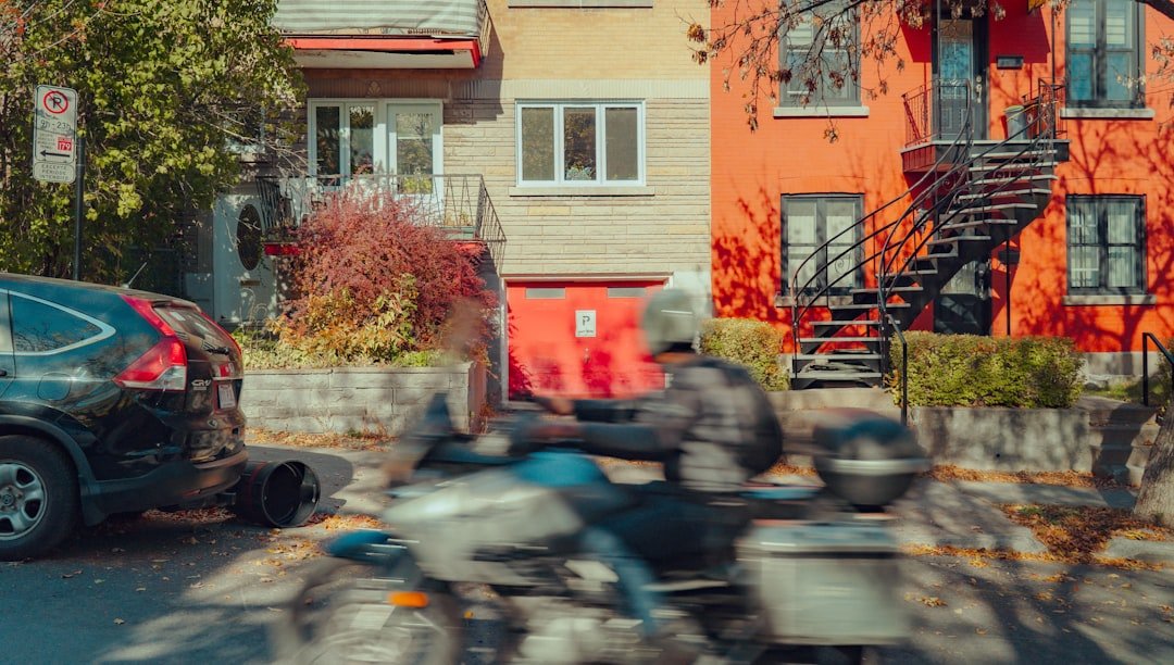 Person riding a motorcycle down a street.