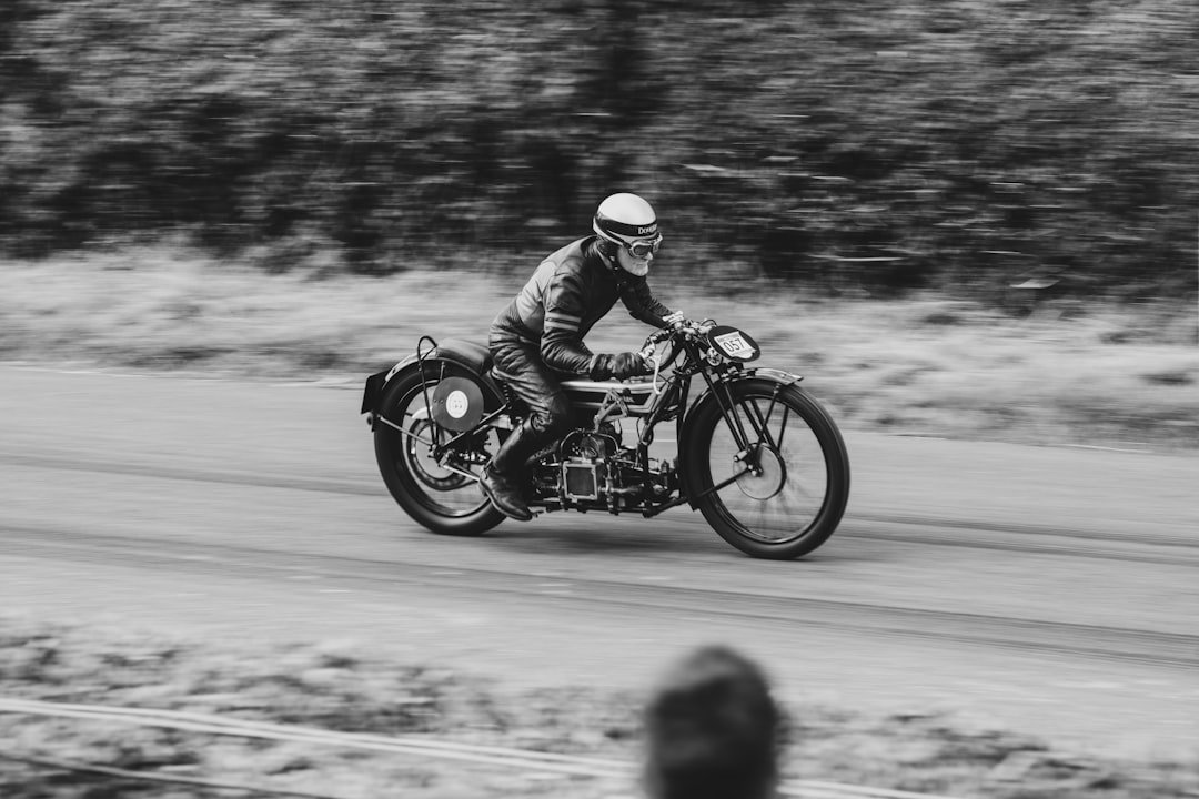 Rider on vintage motorcycle racing on a track