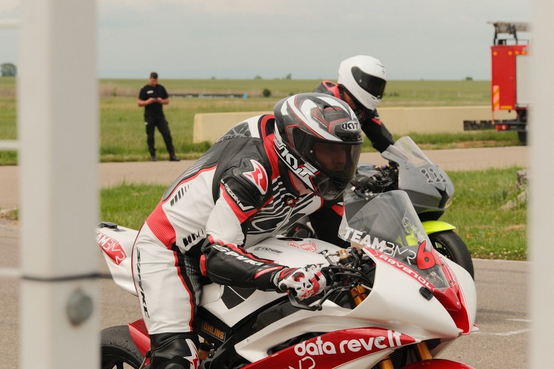 Two motorcycle racers in full gear on track