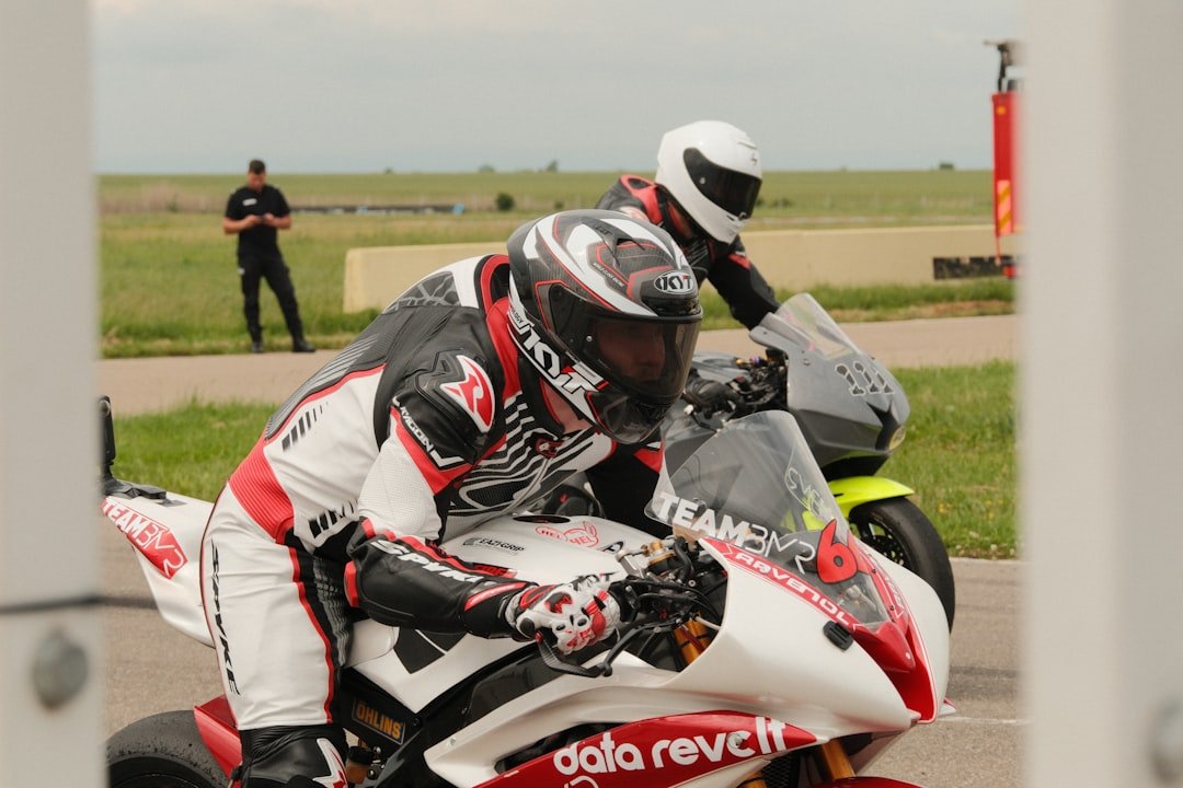 Two motorcycle racers in full gear on track