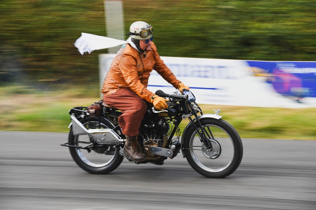 Man in vintage clothing riding an old motorcycle