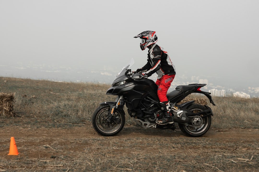 a person riding a motorcycle on a dirt road