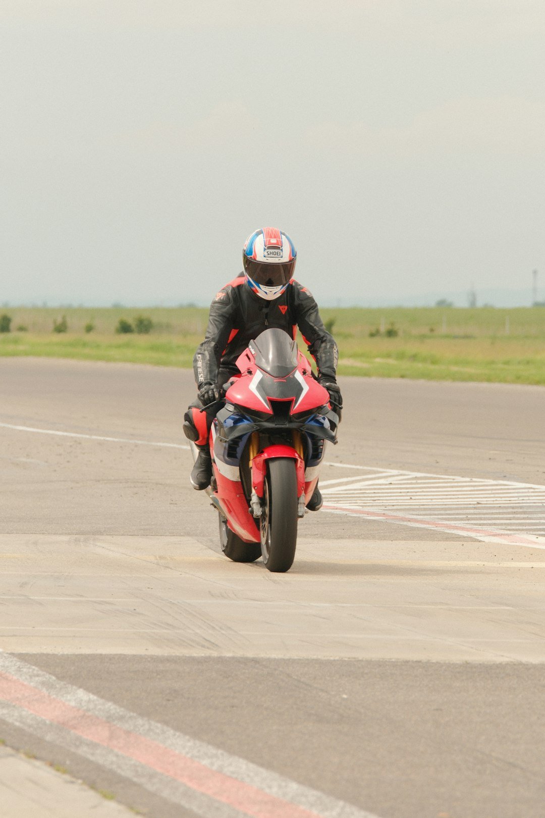 Motorcyclist in racing gear on a red sportbike