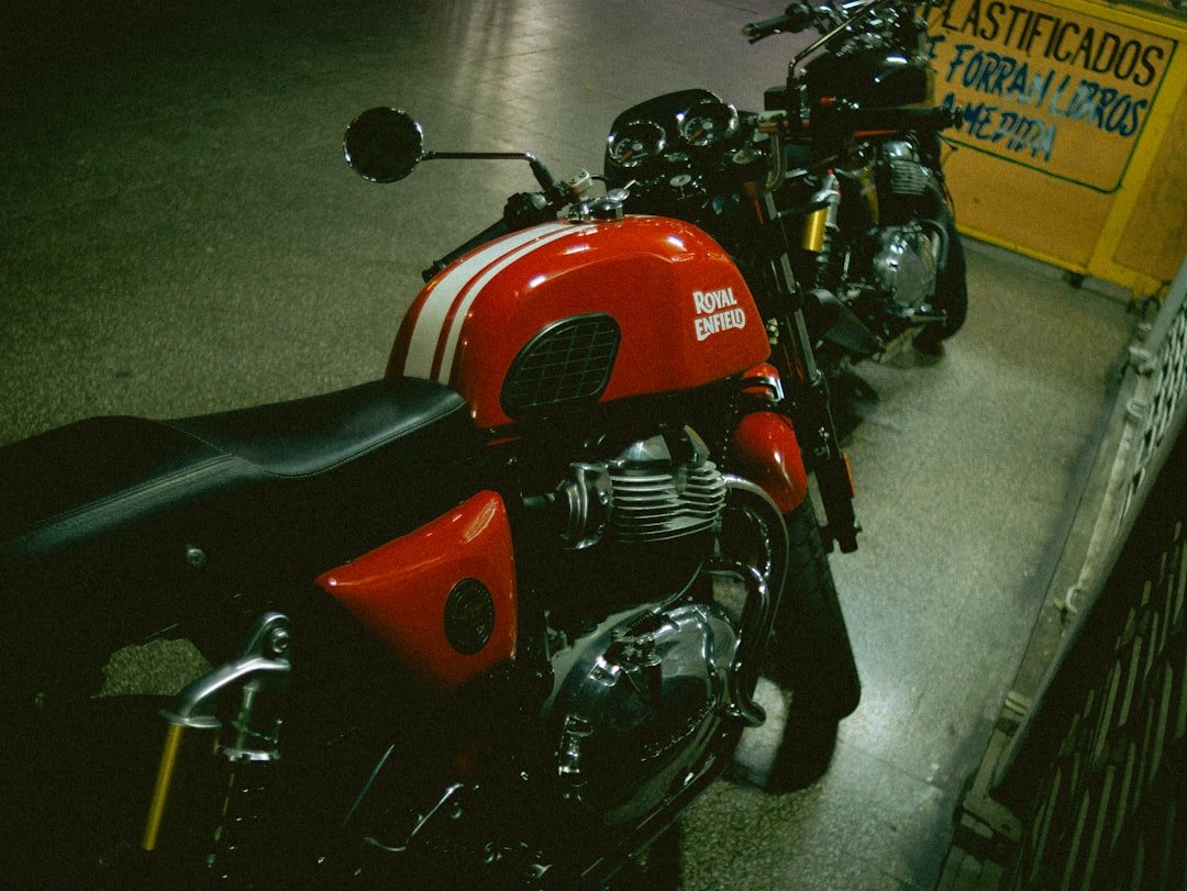 Two parked motorcycles, one red and white.