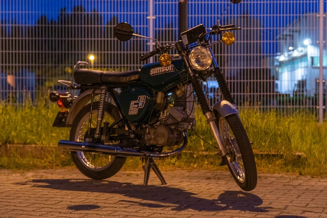 A vintage motorcycle is parked at night.