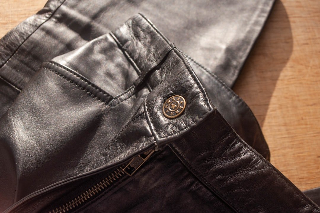 Leather pants with a button and zipper detail.