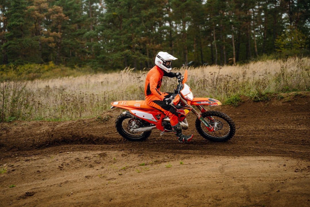 A person riding a dirt bike on a dirt road