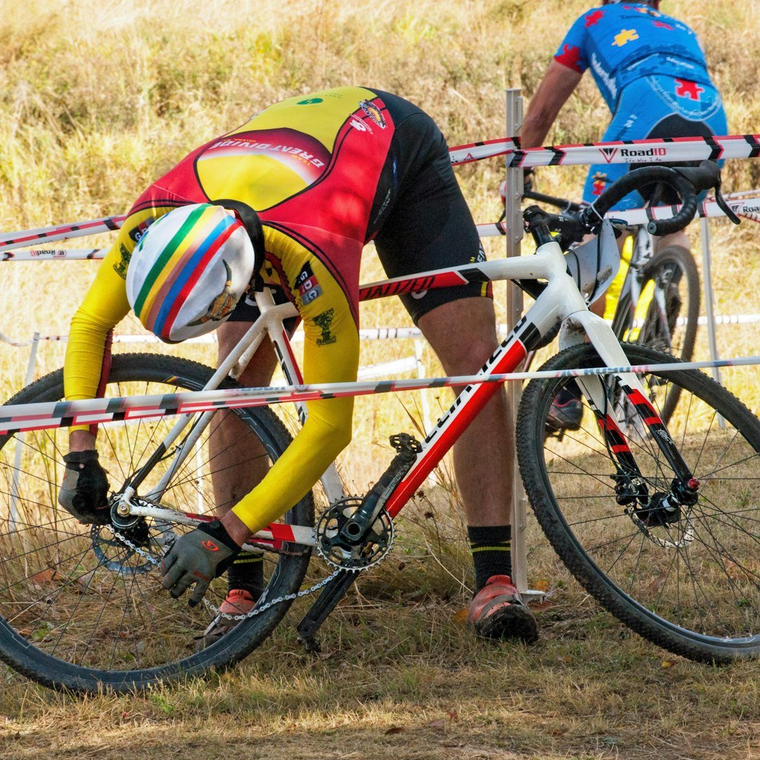 woman in pink tank top riding on red bicycle during daytime