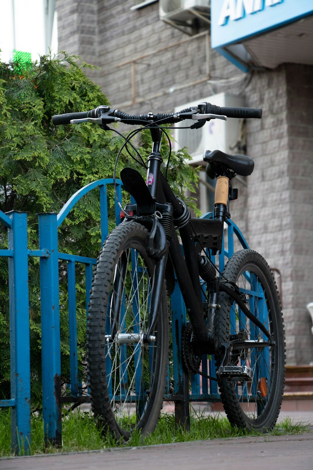 a bicycle leaning against a blue fence