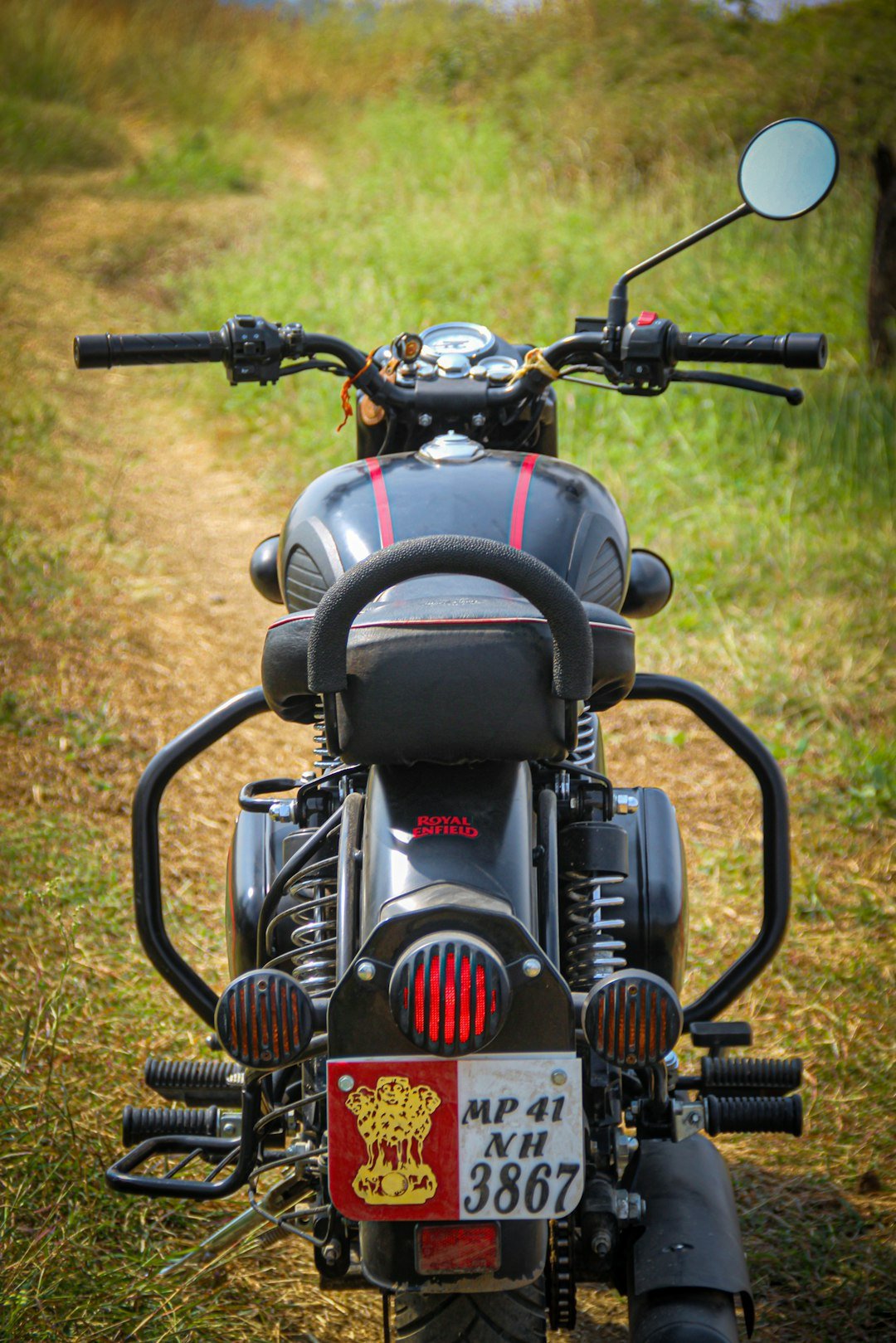 a motorcycle parked on the side of a dirt road