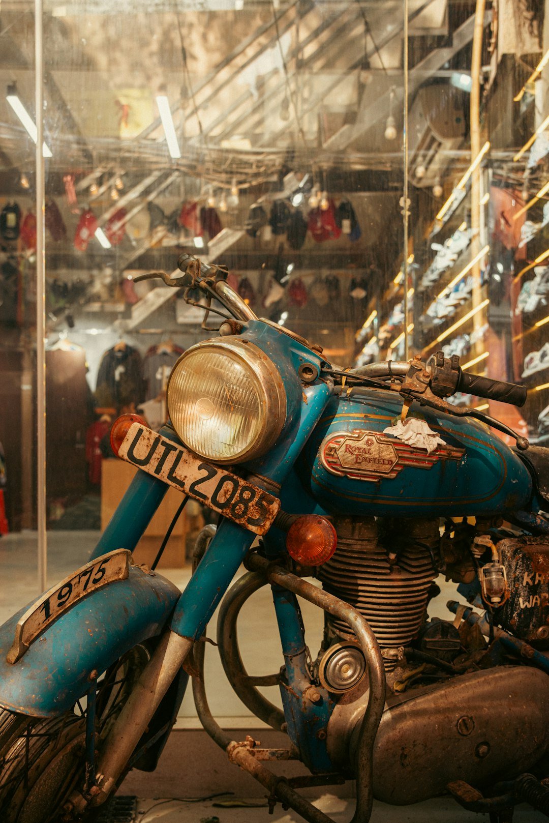 A vintage blue motorcycle with a license plate.